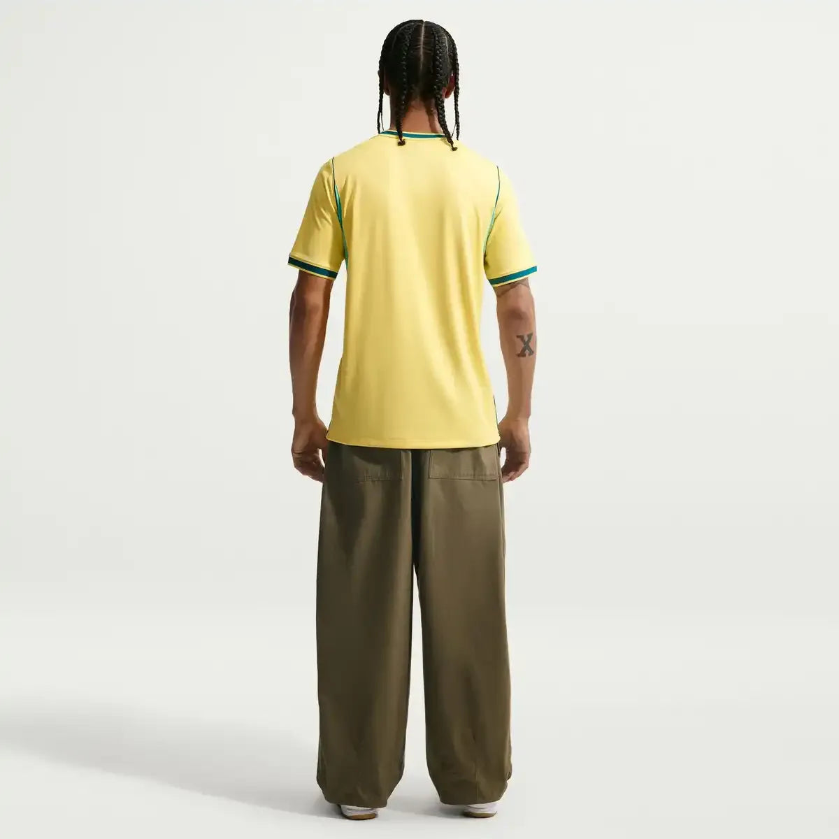 Person wearing a yMen's 2026 brazil home stadium jersey back view