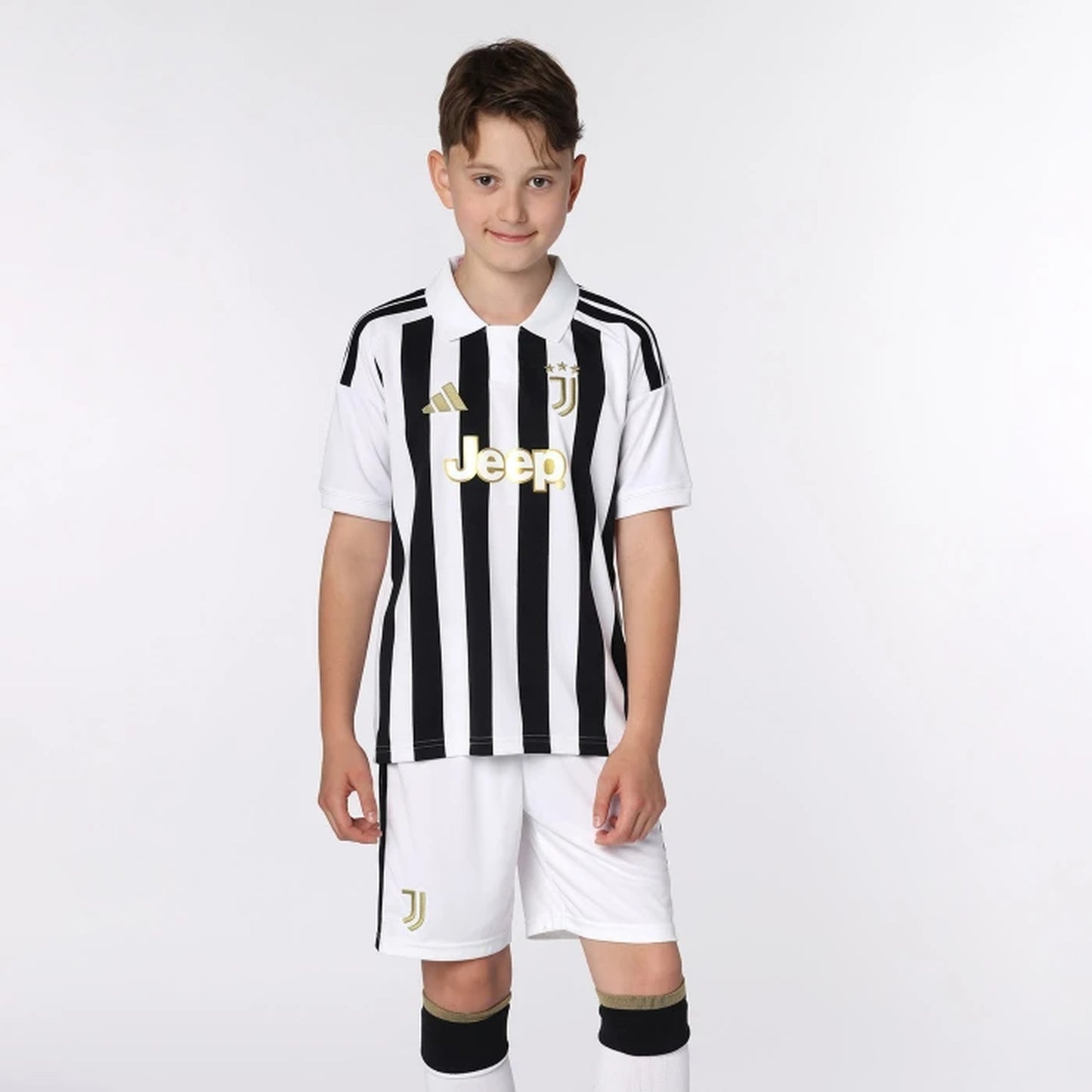 Young boy wearing Juventus 2026/27 home soccer jersey