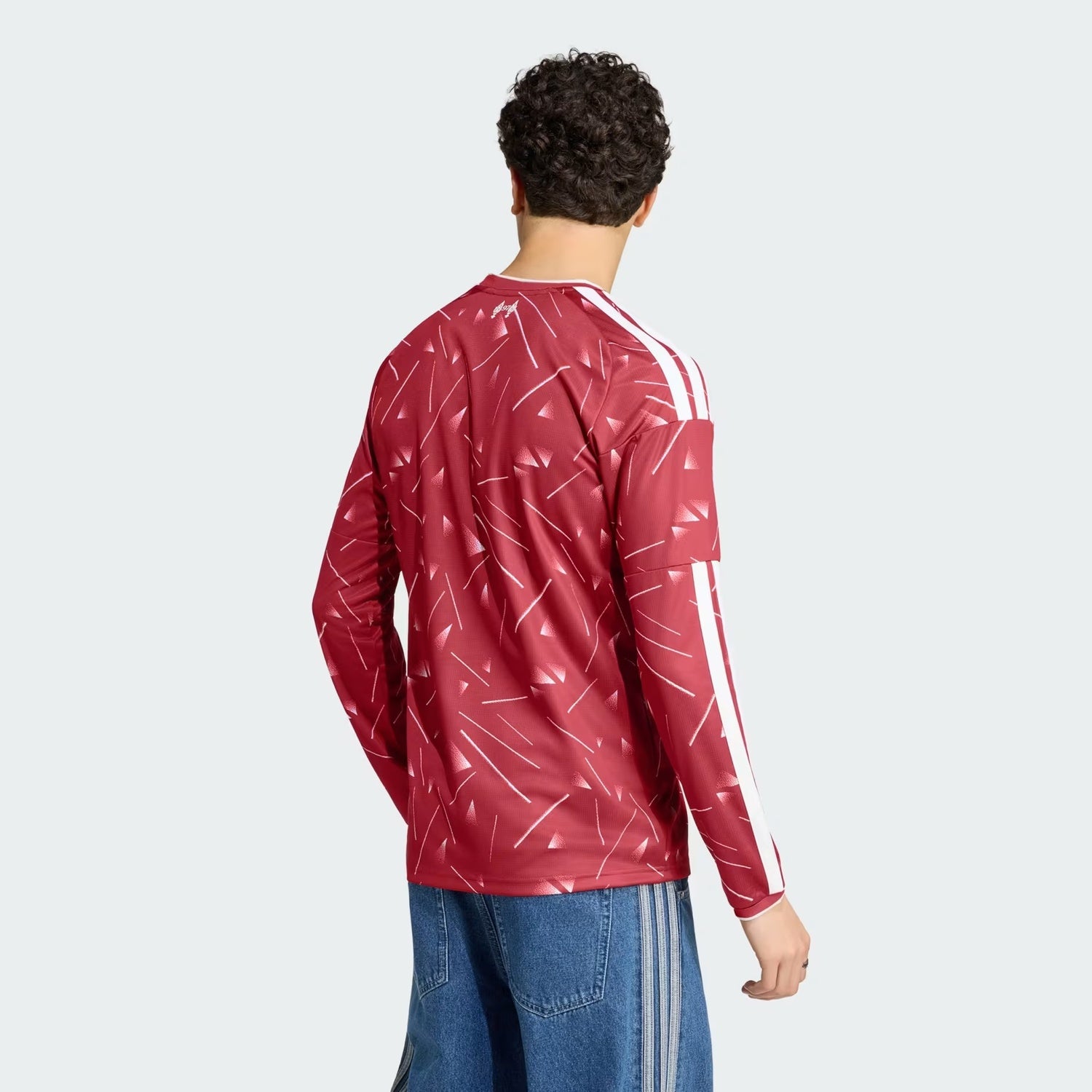 Side view of model wearing Liverpool 2026/27 long sleeve home kit