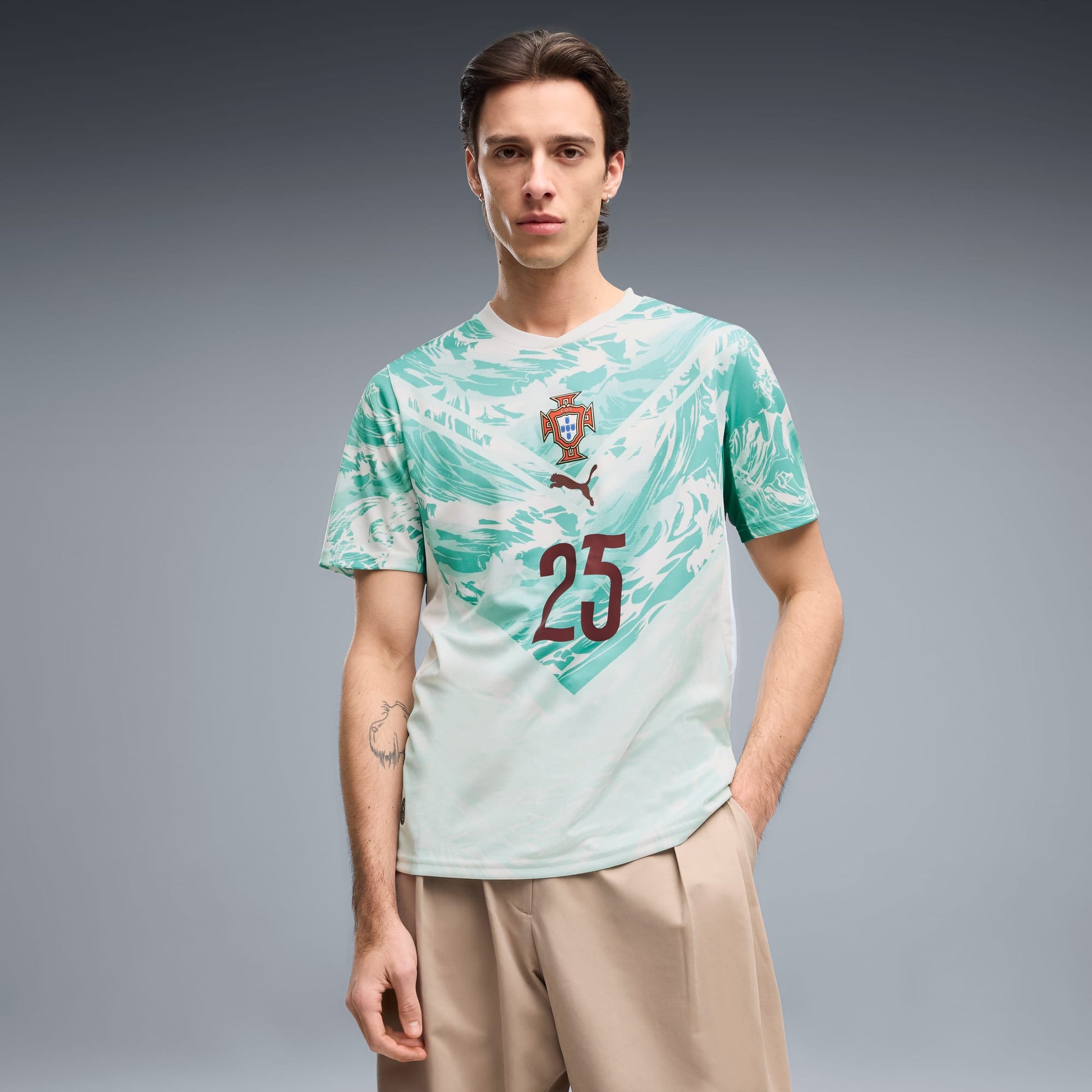 Man wearing a Portugal 2026 World Cup Away Stadium Replica Jersey with N. Mendes #25 printing
