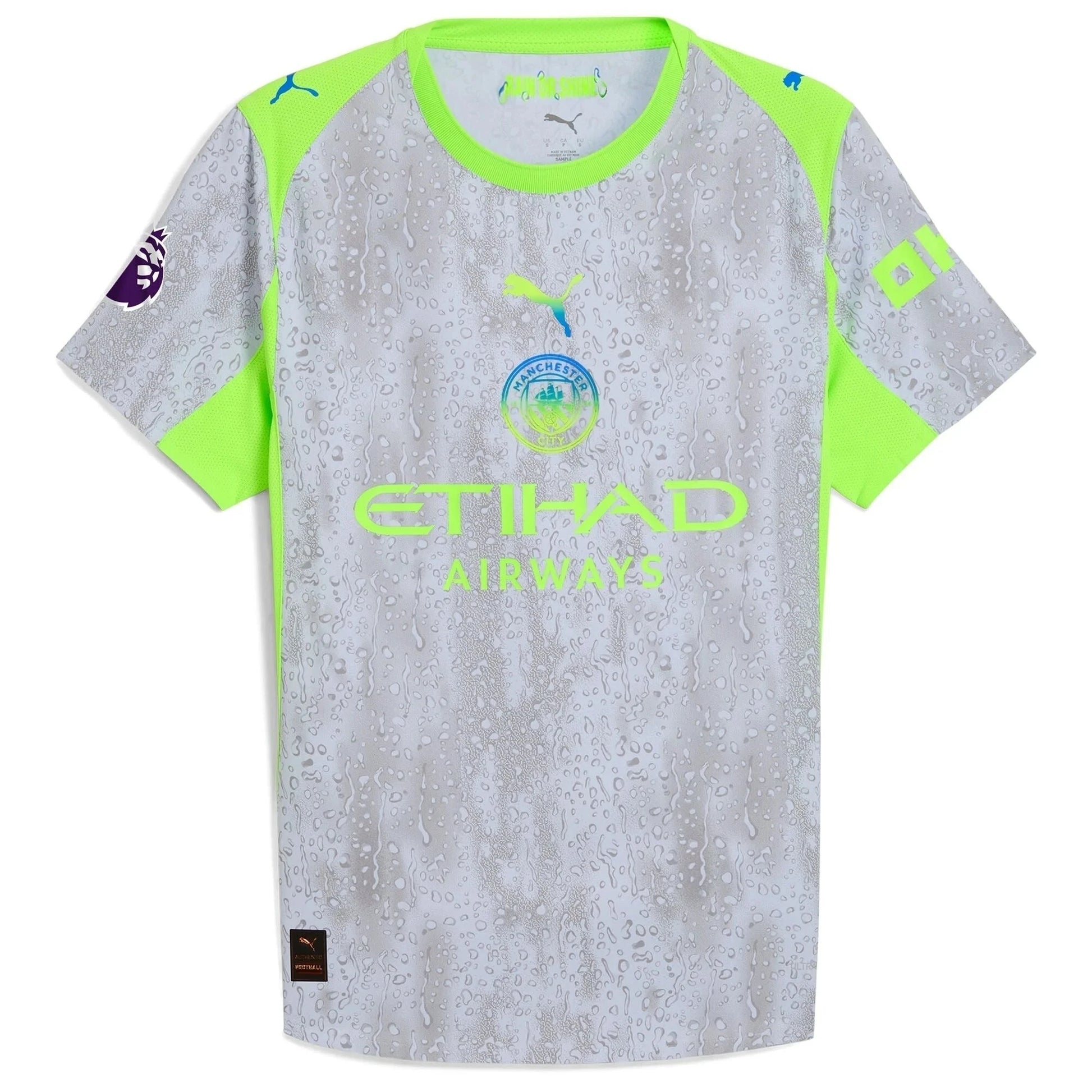 Flat lay of Manchester City 2025/26 third replica jersey front showing club crest and teal sponsor details