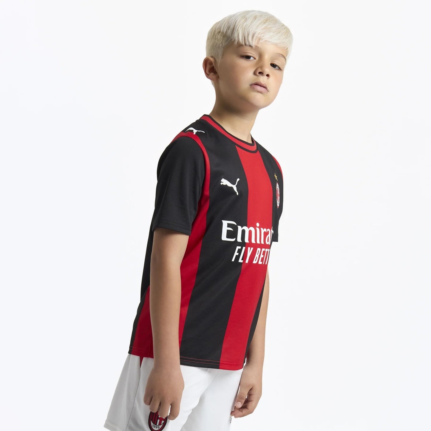 Child wearing AC Milan 2026/27 home soccer kit outfit