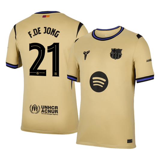 Beige sports jersey with black text and logos on a clear background