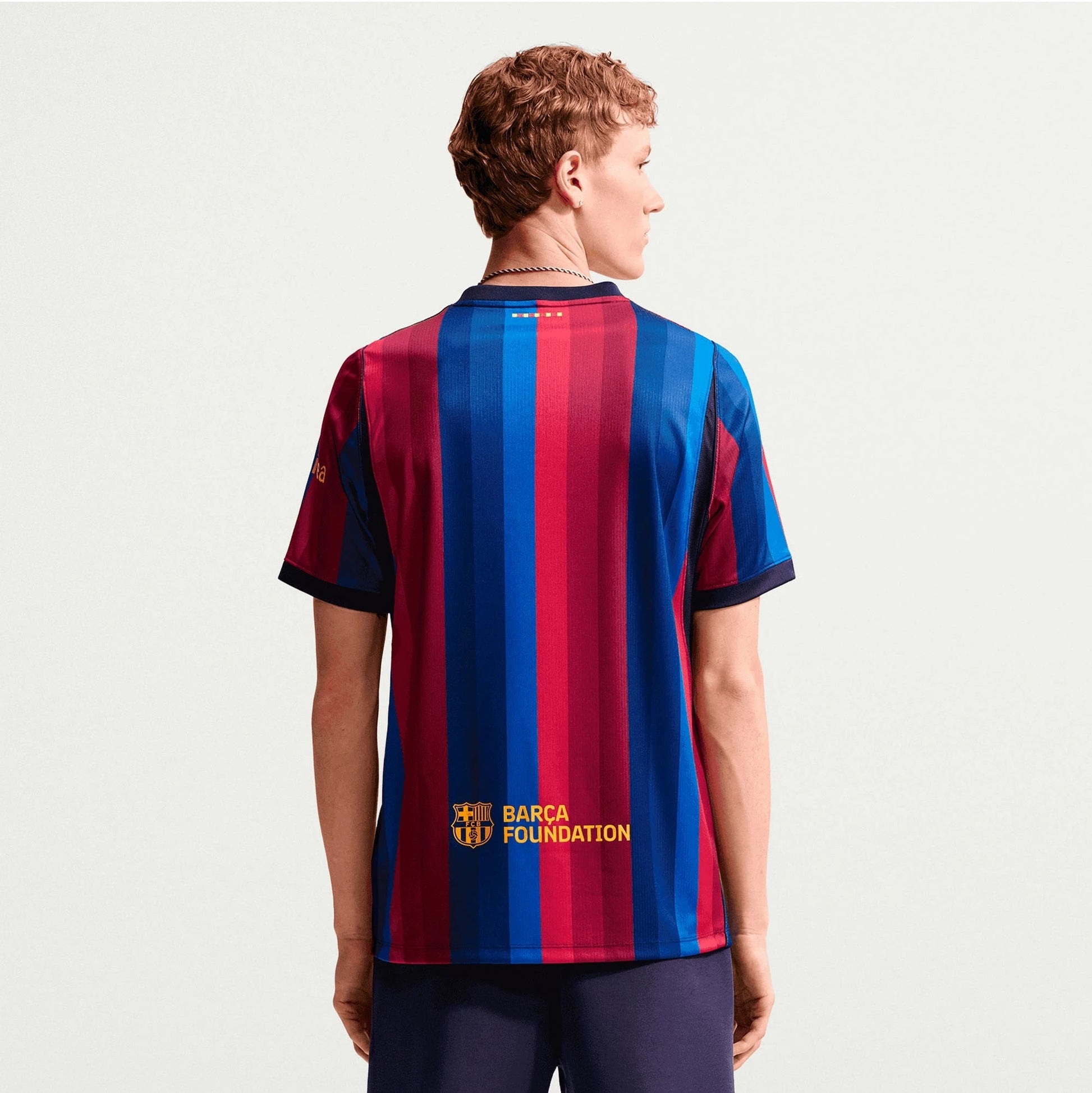 Man Wearing A Barcelona 2026/27 Home Stadium Replica Jersey Back View