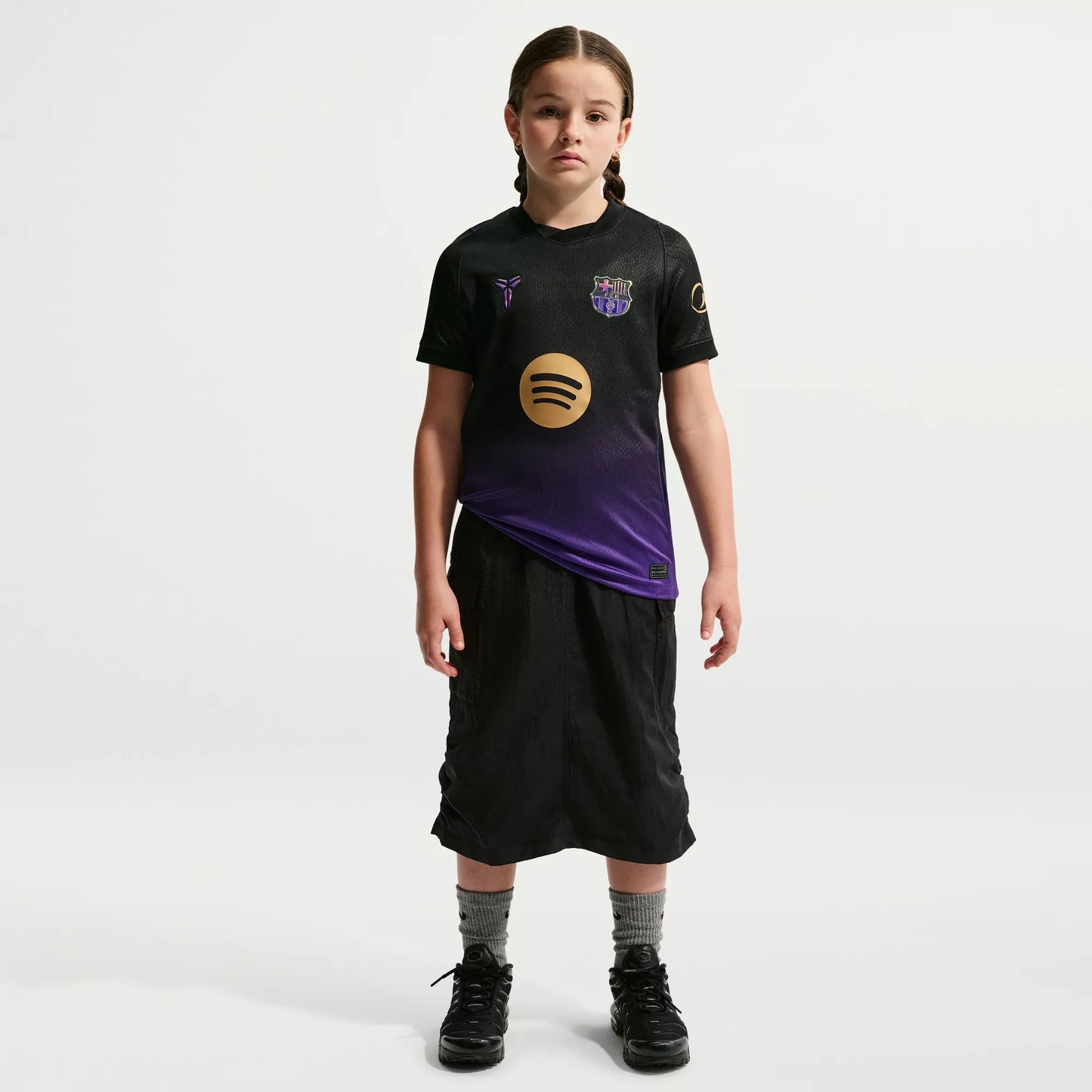 A young girl modeling a Barcelona Youth 2026_27 Away Stadium Replica Custom Jersey