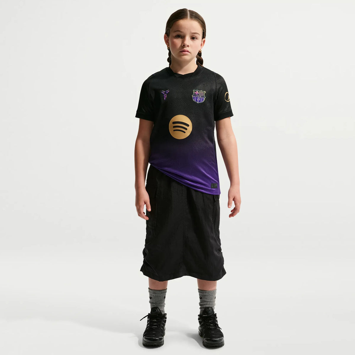 A young girl modeling a Barcelona Youth 2026_27 Away Stadium Replica Custom Jersey