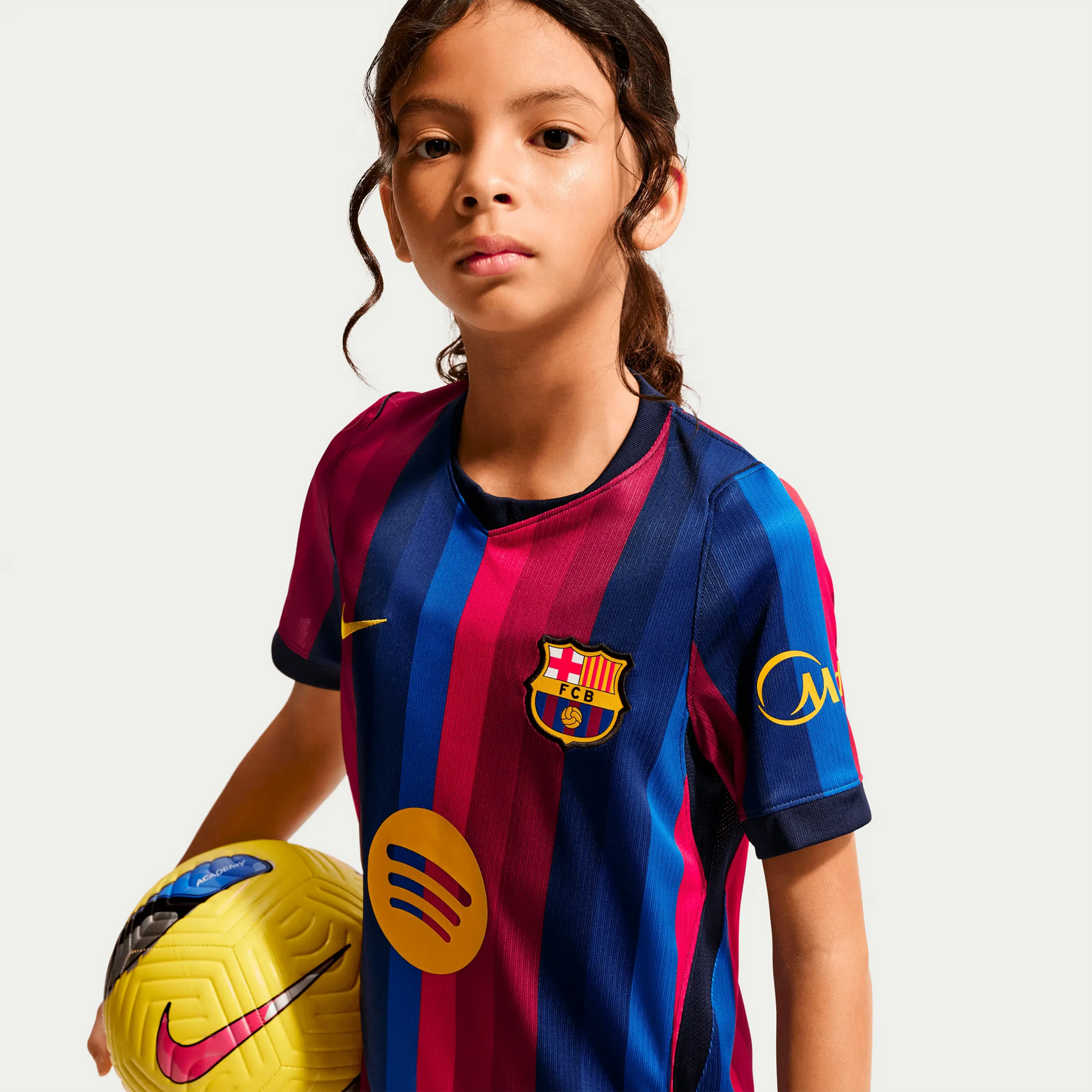 A Girl Wearing A 2627 Barcelona Home Jersey With A Ball