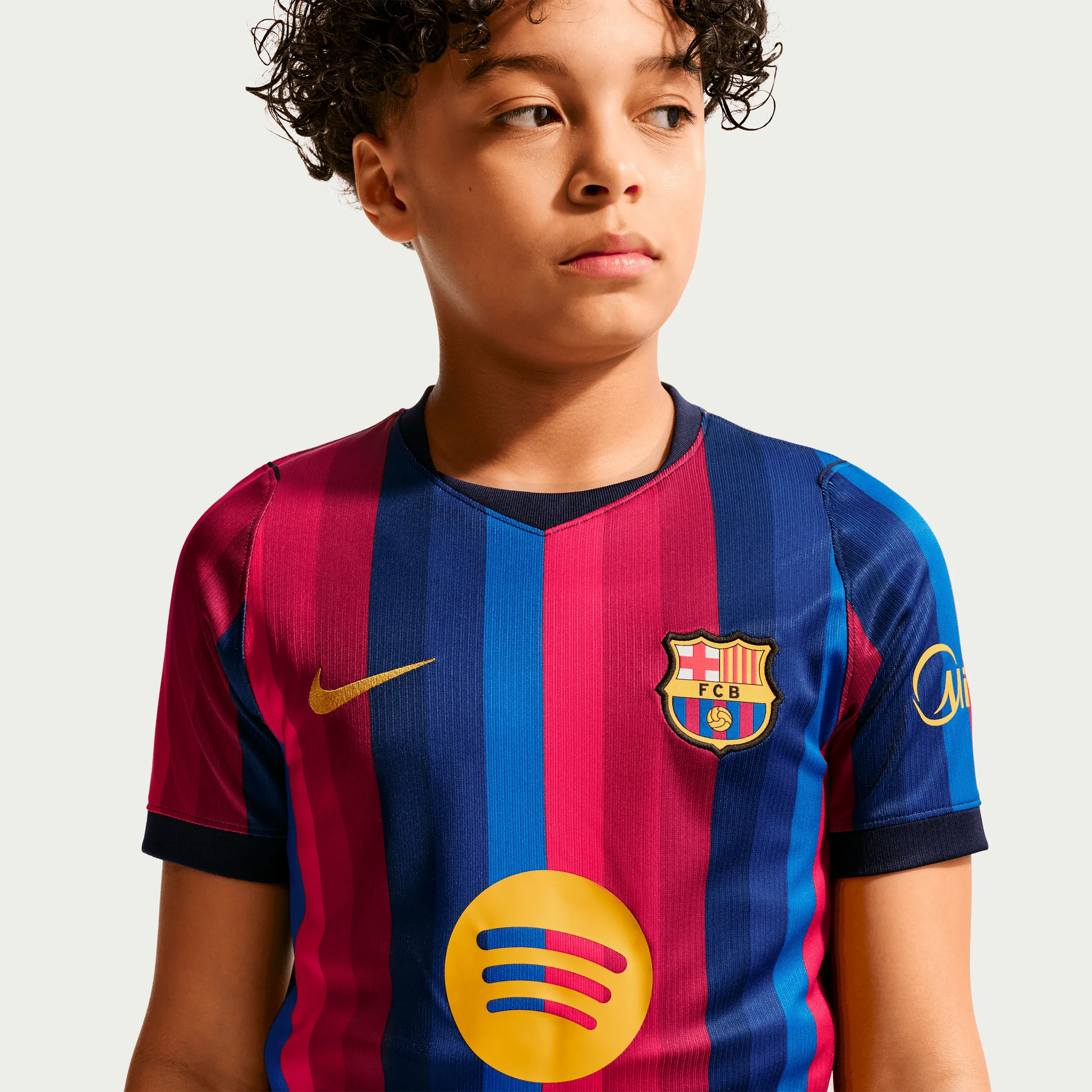 A Boy Wearing A 2627 Barcelona Home Jersey  