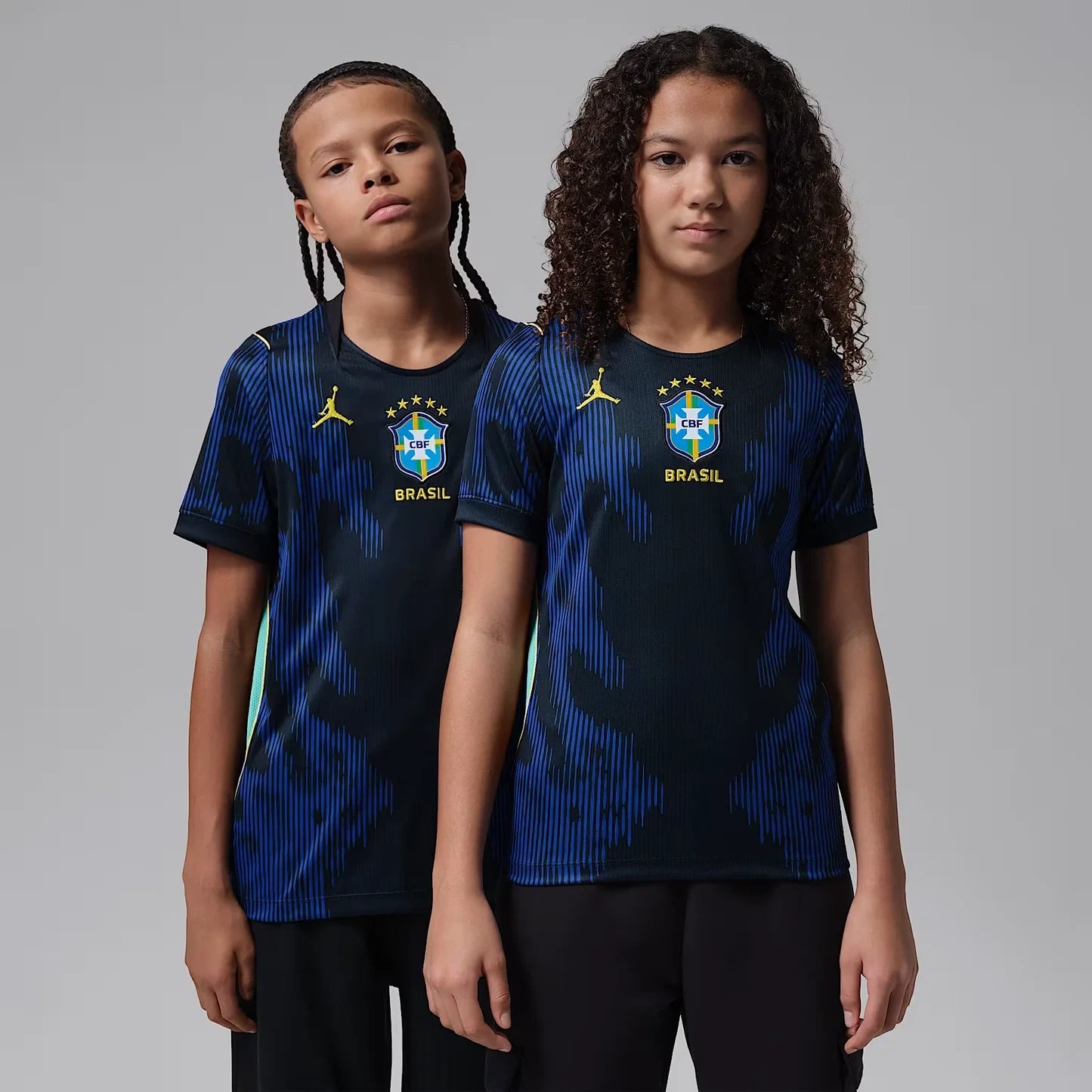 A Boy And Girl Wearing  Brazil 2026 World Cup Away Kids Stadium Replica Jersey