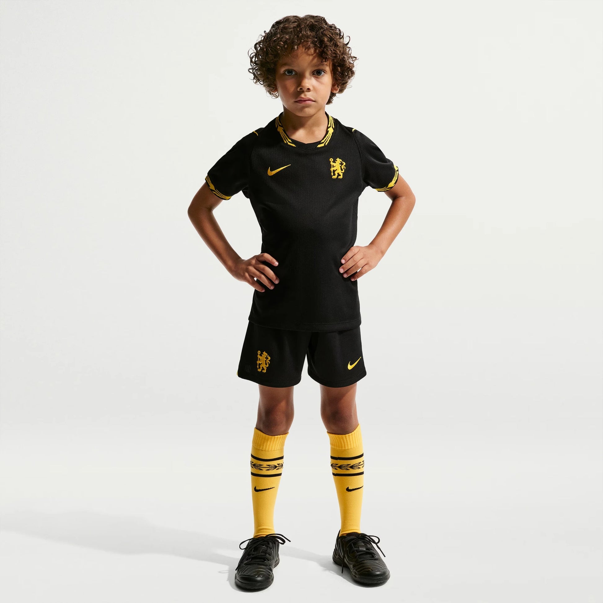 A young boy modeling a black Nike Chelsea Preschool 2026/27 Away Stadium Replica Kit Set 