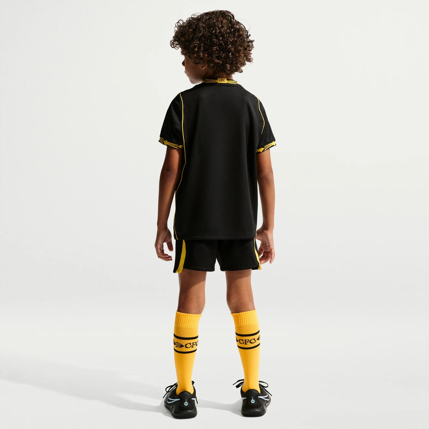 A child model shown from the back wearing a black Chelsea Preschool 2026/27 Away Stadium Replica Kit Set