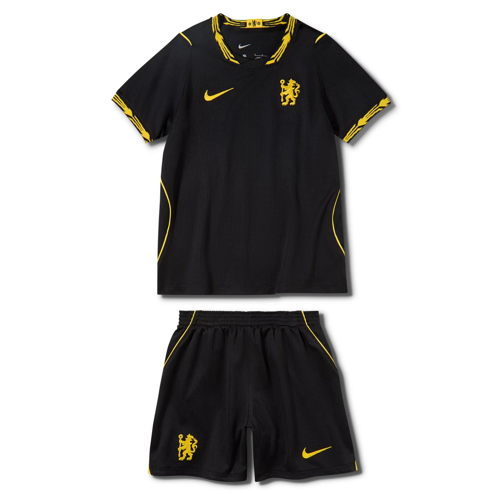 A black Nike soccer kit set for Chelsea FC, featuring a short-sleeve jersey and matching shorts. The jersey is black with yellow trim on the collar, sleeve cuffs, and sides, featuring the yellow Nike swoosh and Chelsea lion crest.