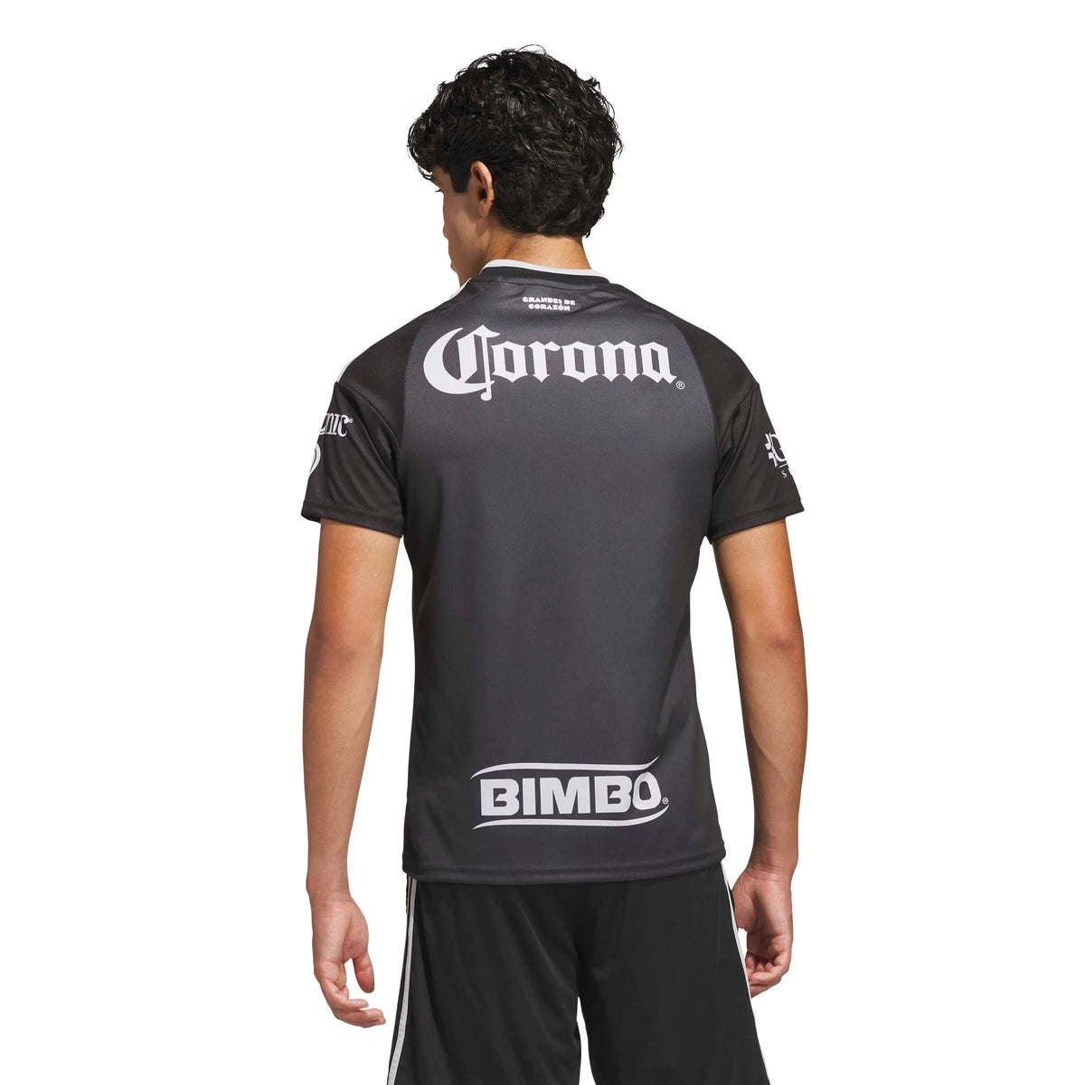 A man viewed from the back wearing a Club America 2026-2027 away black replica football shirt