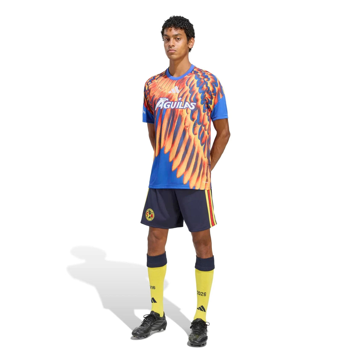 A male model wearing a Club America 2026-2027 home blue pre-match top