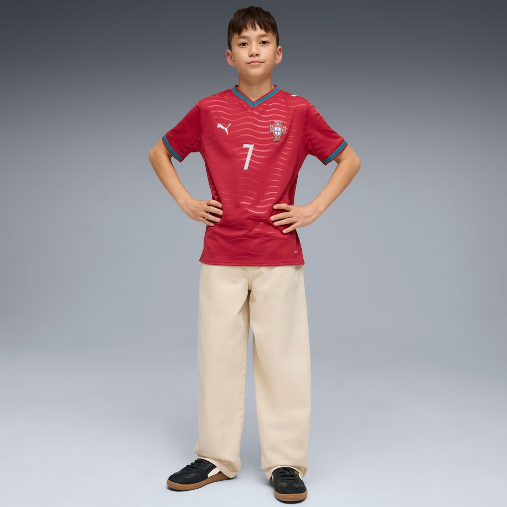 boy wearing a red Portugal 2026 World Cup home Kids Stadium Replica Jersey - Ronaldo #7