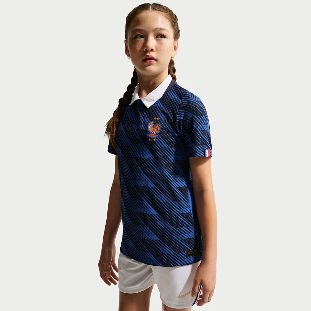 girl wearing a France 2026 World Cup Home Kids Stadium Replica Kit