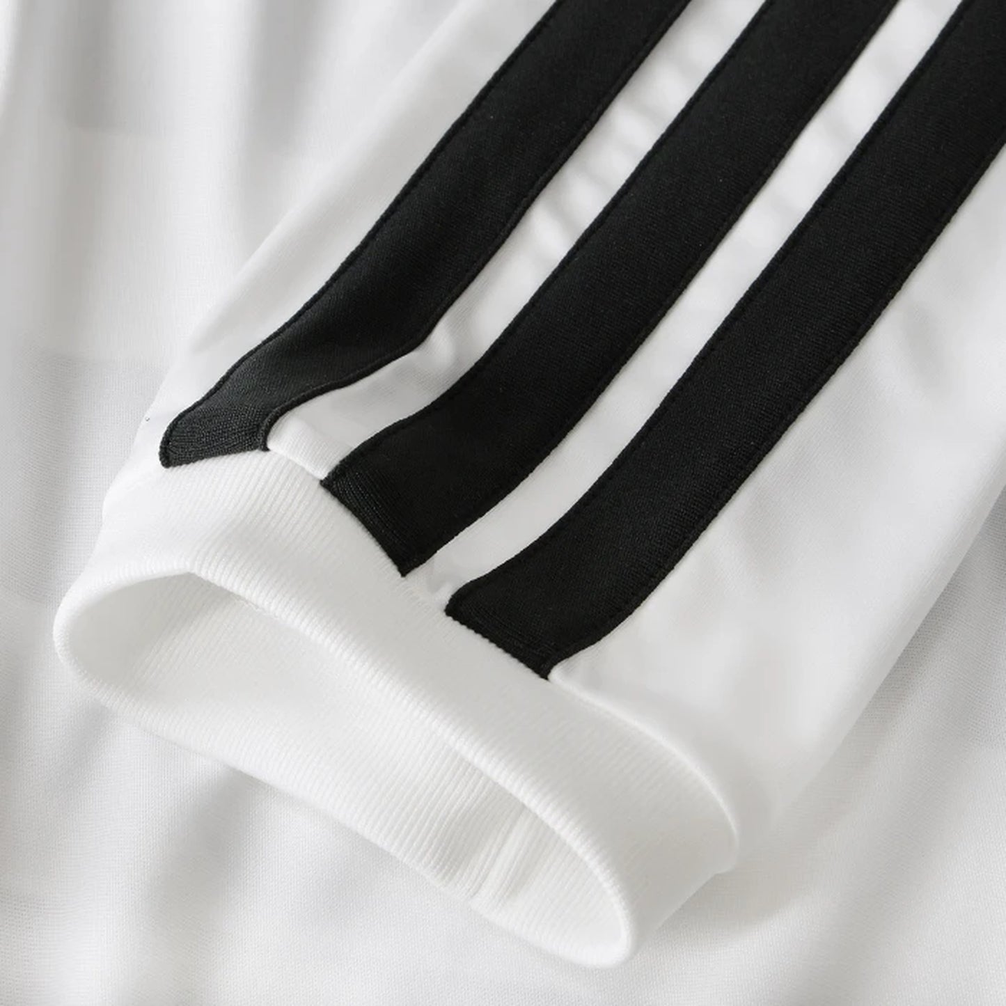 Detail view of iconic three-stripe sleeve design on Juventus home kit