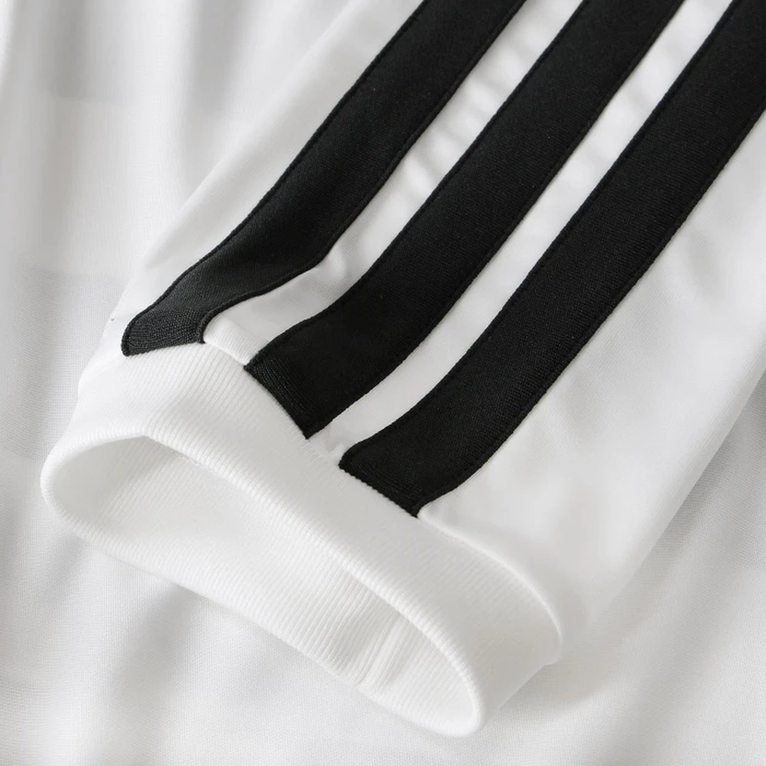 Detail view of iconic three-stripe sleeve design on Juventus home kit
