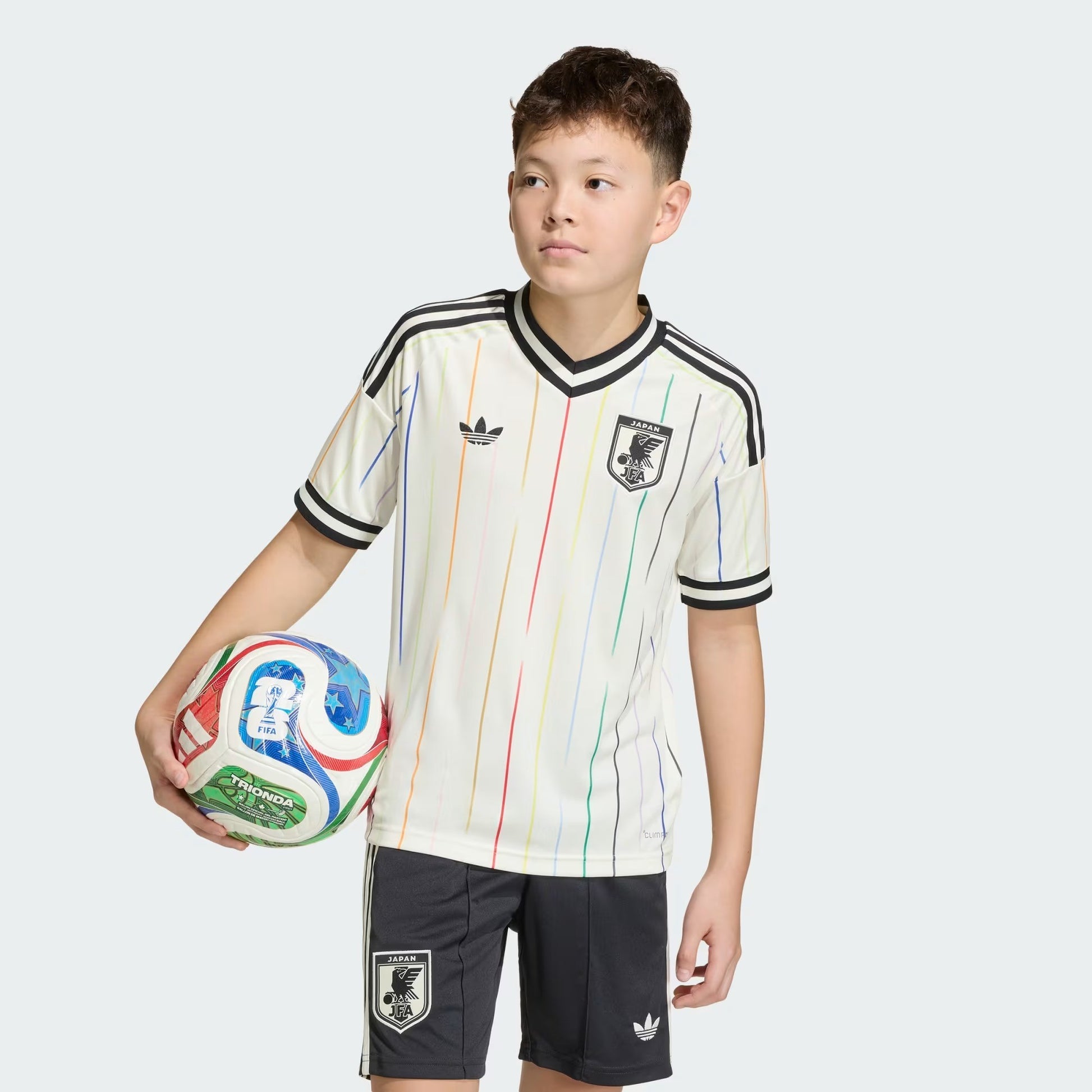 boy wearing a Kids Japan 2026 World Cup away stadium replica jersey