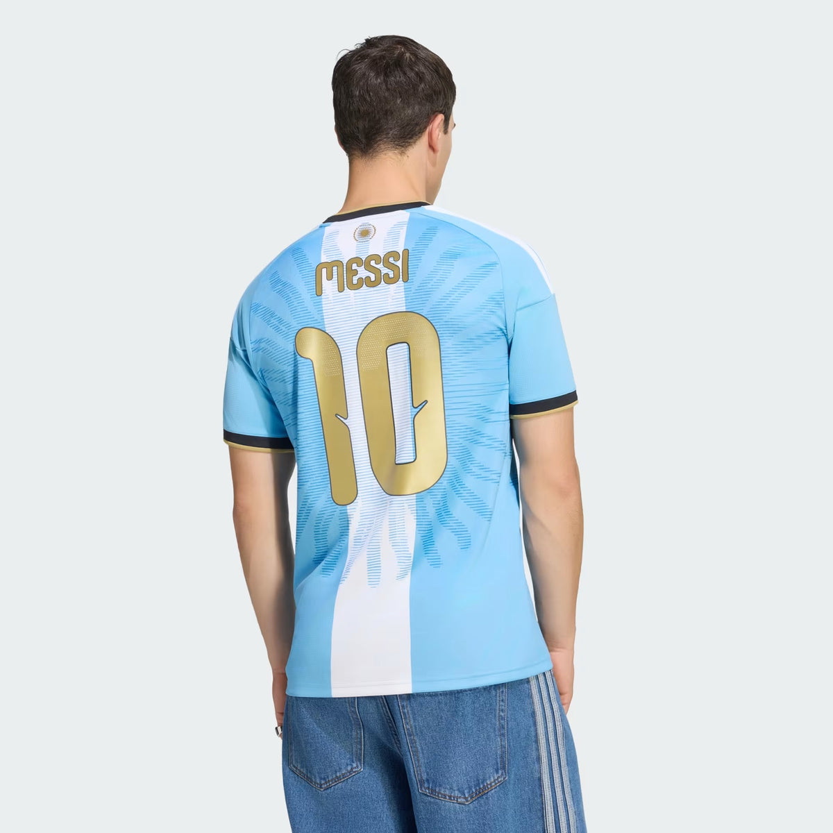 Back View of Man Wearing a Argentina national team AFA x Messi light blue replica football shirt with Lionel Messi name and number 10 printing 