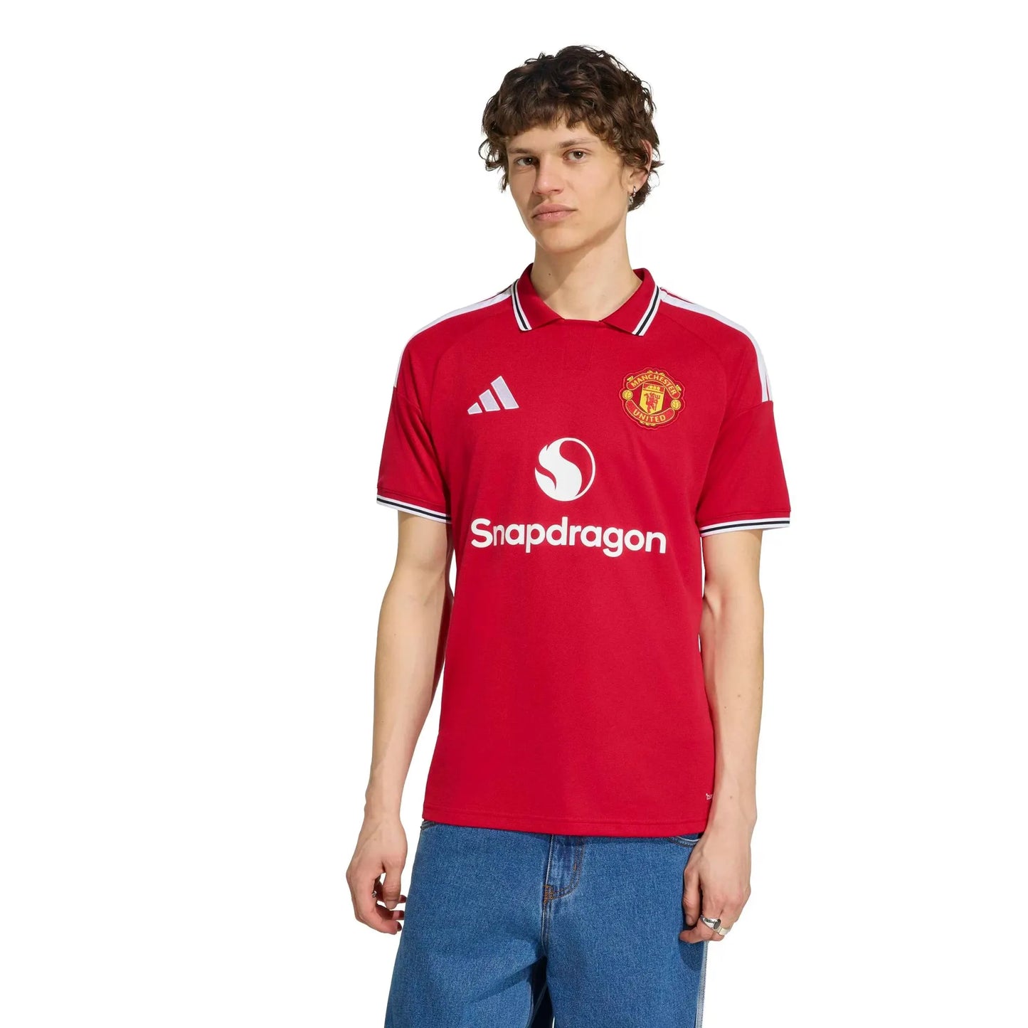 Person wearing a red Manchester United jersey with Adidas and Snapdragon logos on a white background