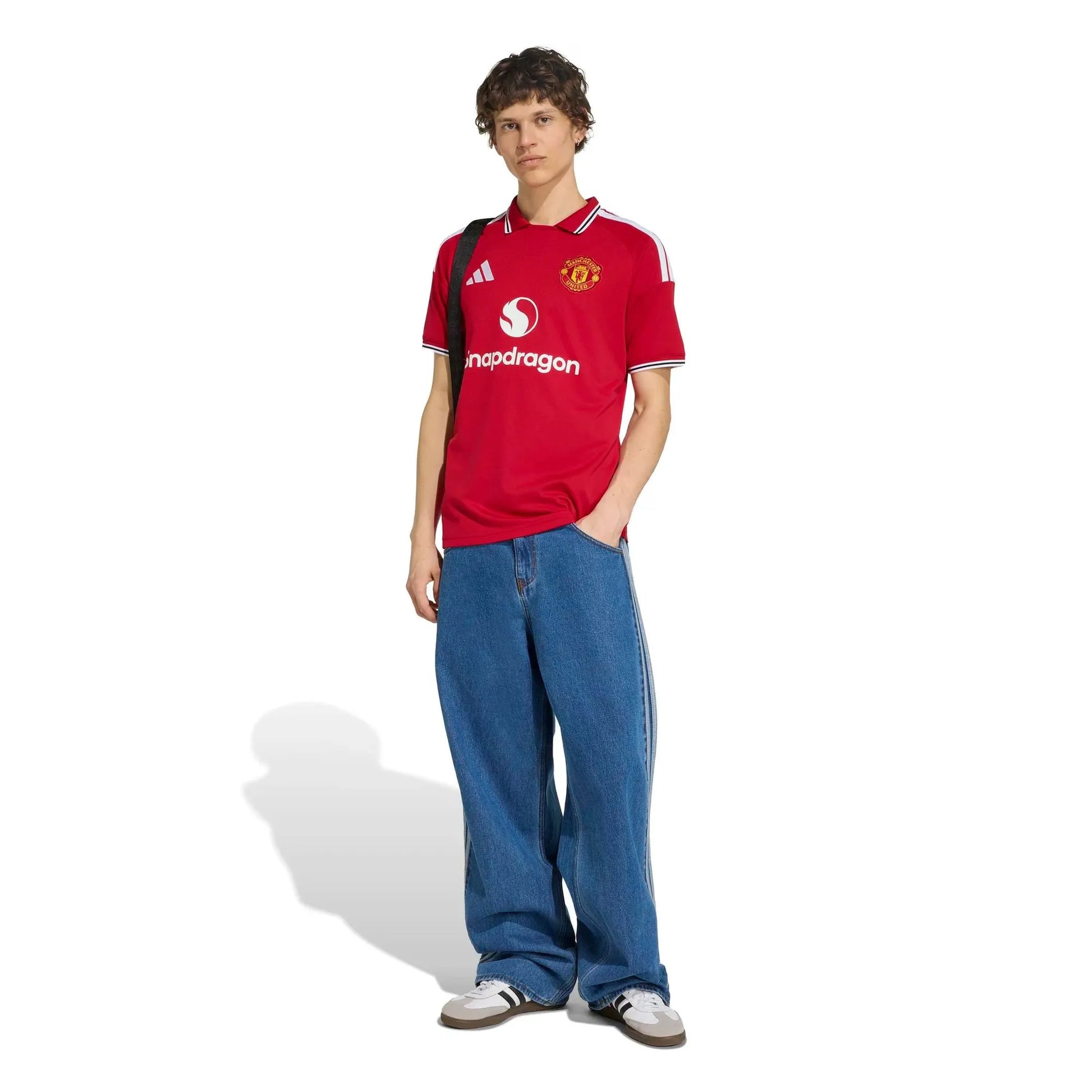 Person wearing a red 2026/27 Manchester united home jersey on a white background