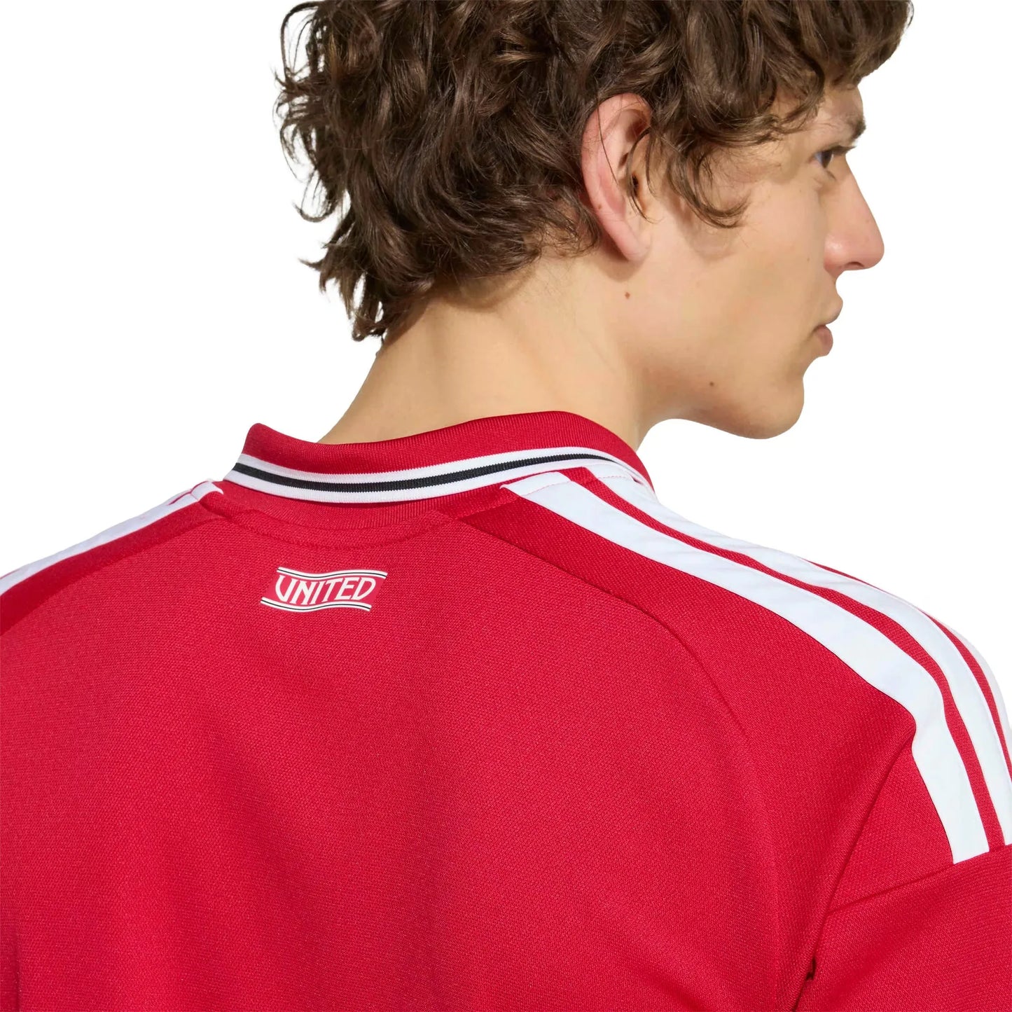 Red sports jersey with white stripes on a person against a white background