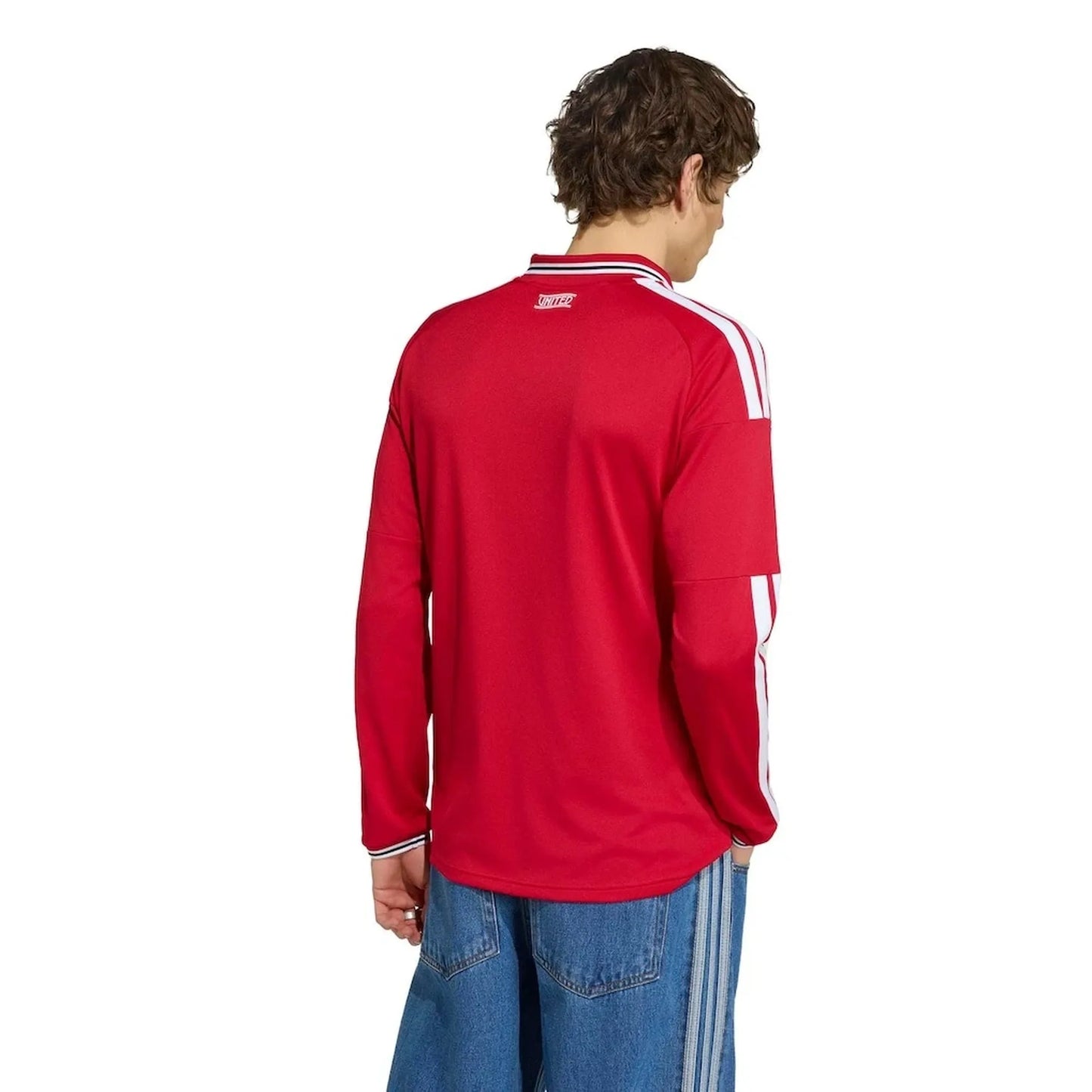Person wearing a red Manchester United 2026/27 Home Stadium Long Sleeve Jersey