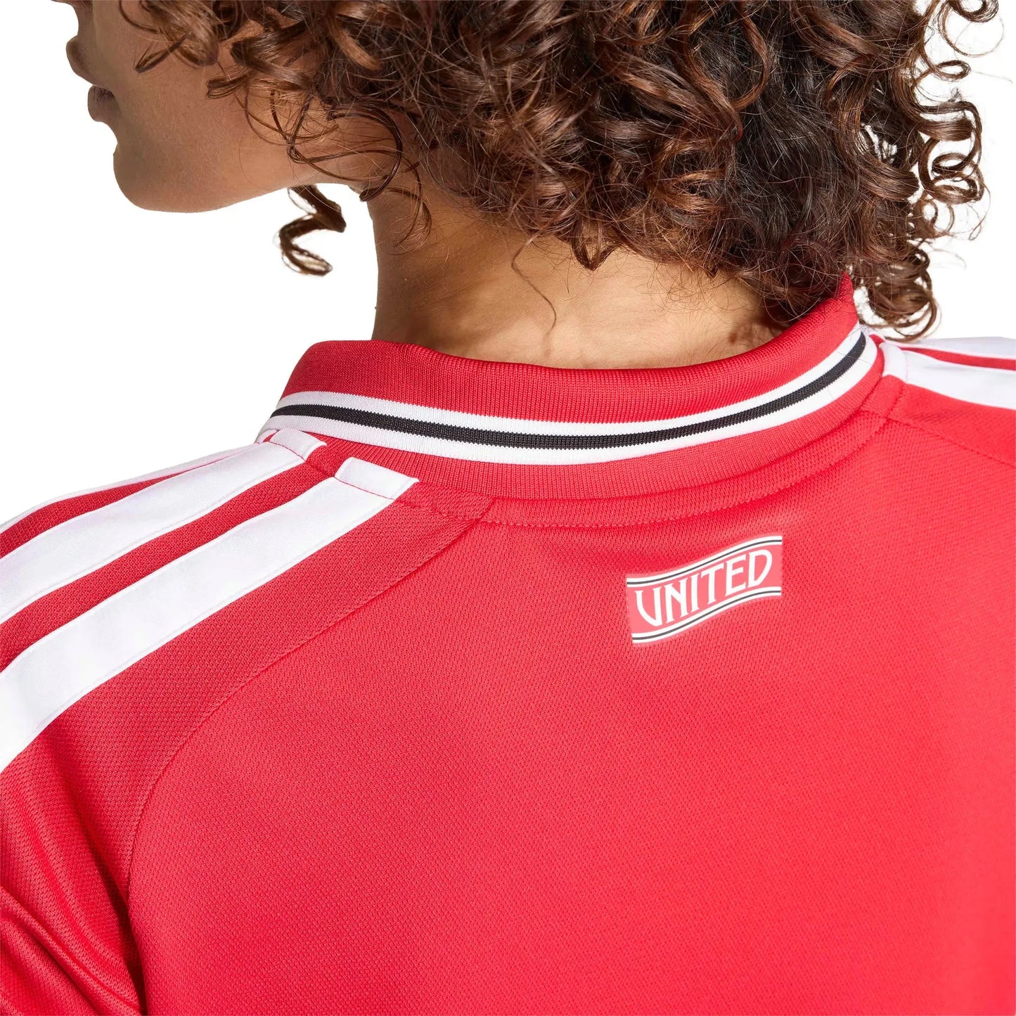 Red sports jersey with 'UNITED' logo on a white background