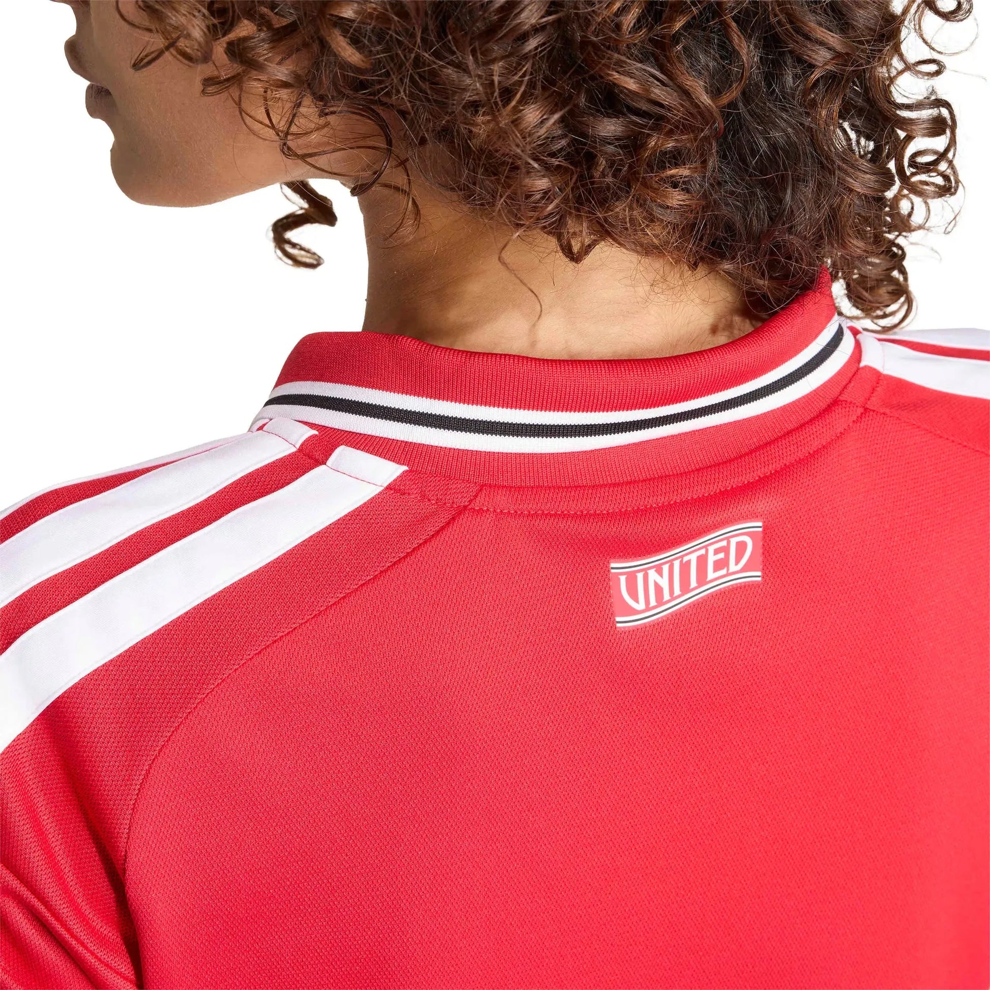 Red sports jersey with 'UNITED' logo on a white background