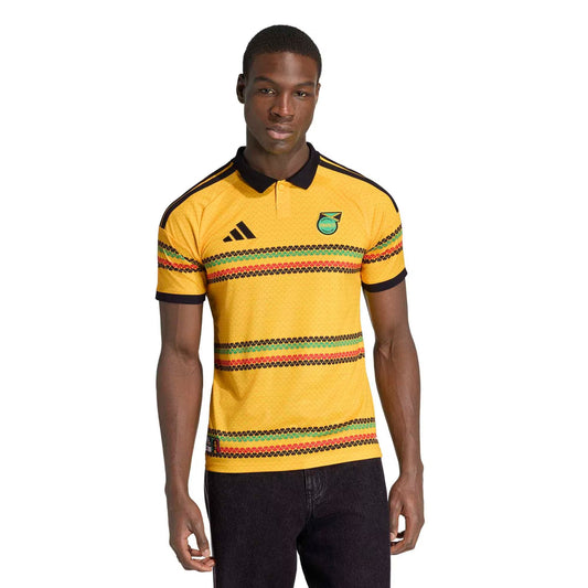 man wearing Jamaica national team 2026 soccer jersey home yellow with classic stripes