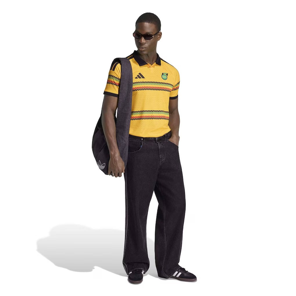 Man wearing Jamaica national team 2026 soccer jersey yellow with classic stripes