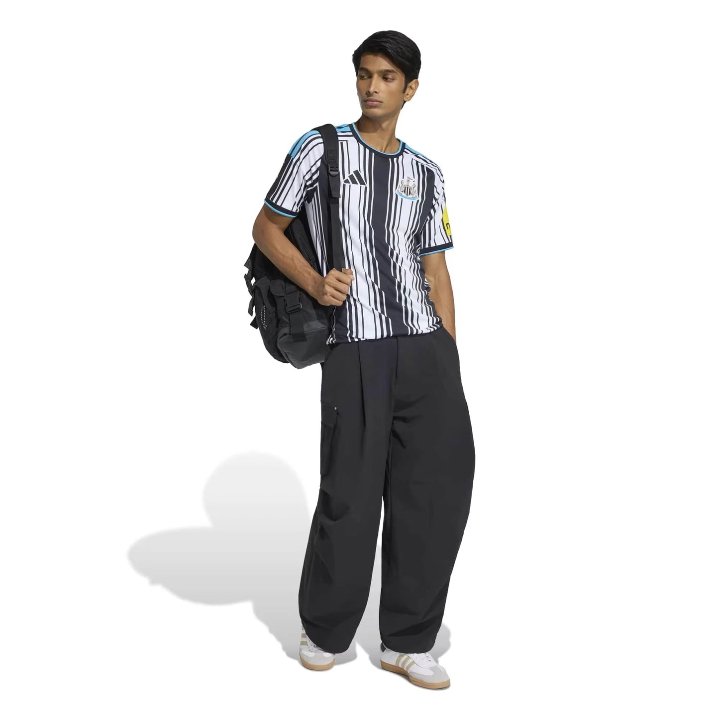 Front View Of A Man Wear A Newcastle United 2026 27 Away Jersey With a Bag