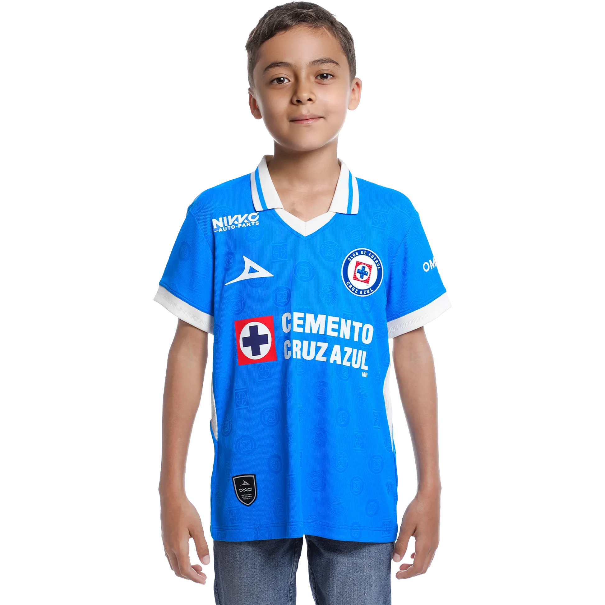 A young boy modeling a bright blue Cruz Azul soccer jersey with white trim, featuring sponsor logos like Cemento Cruz Azul and Nike, set against a plain white background.