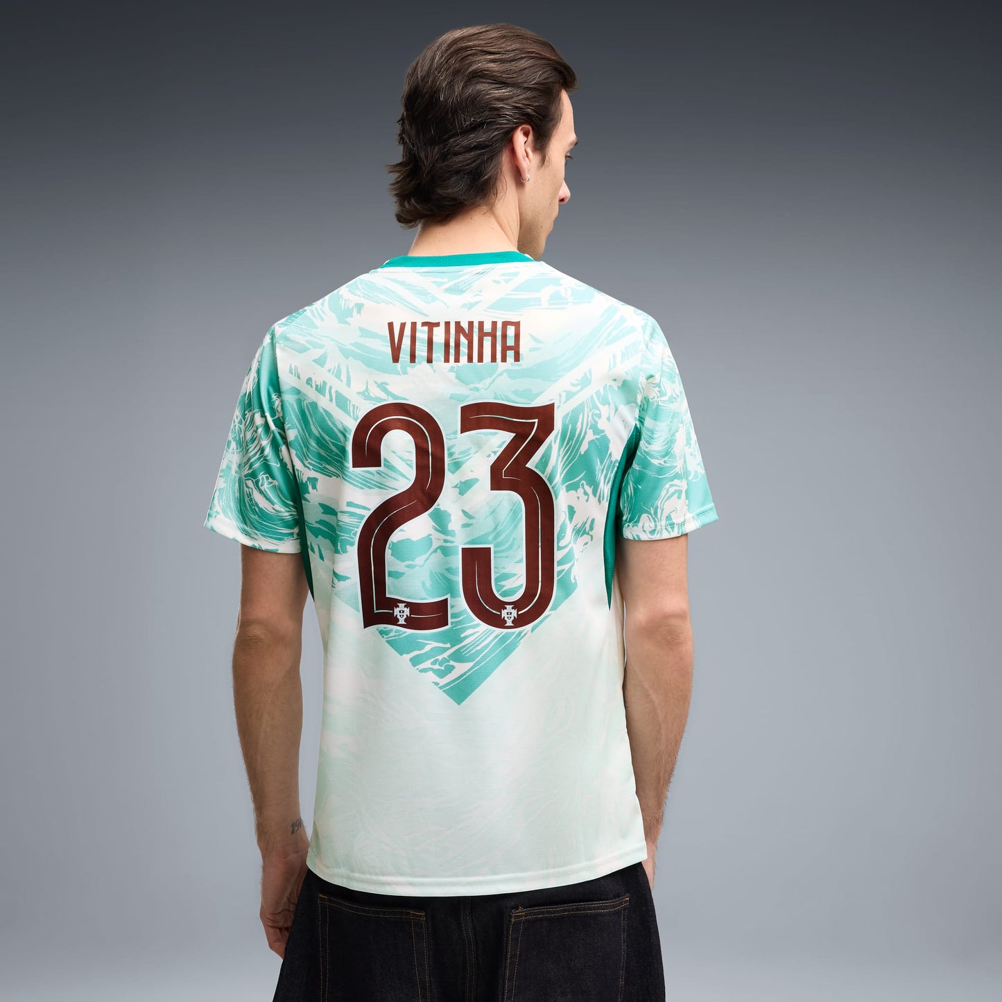 back view of a man wearing a Portugal 2026 World Cup Away Stadium Replica Jersey - Vitinha #23