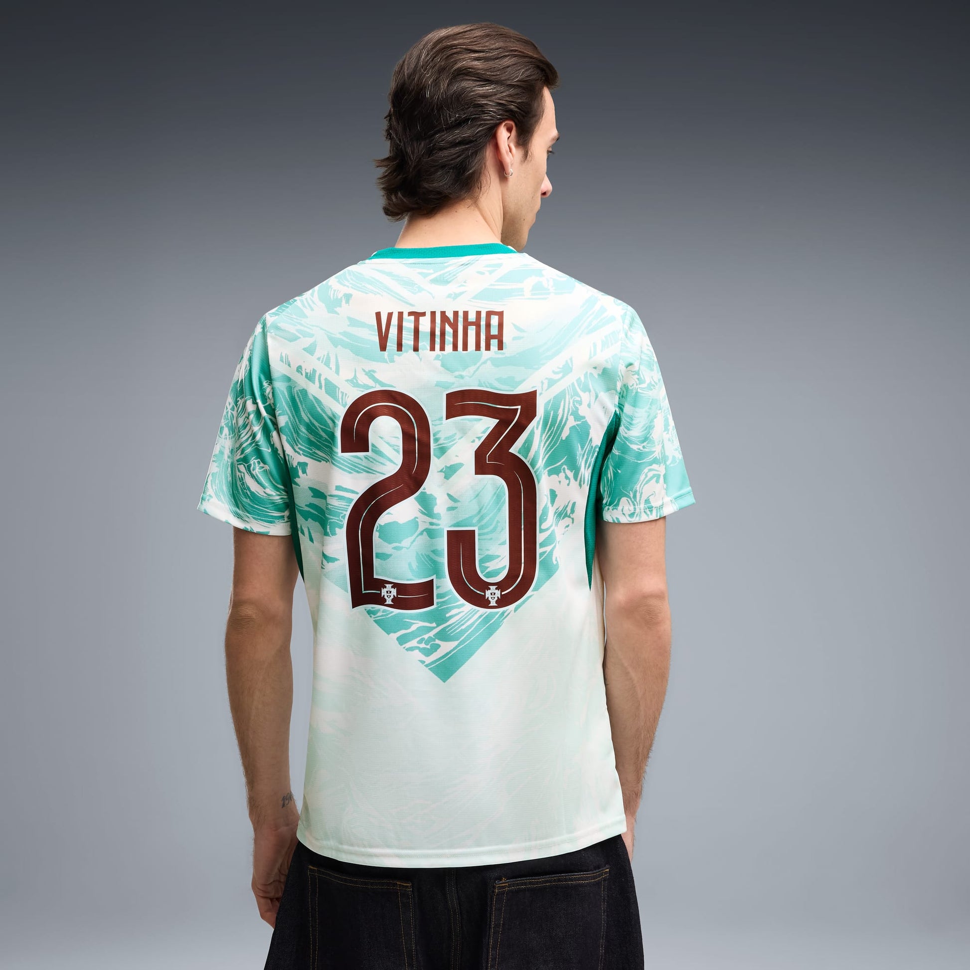 back view of a man wearing a Portugal 2026 World Cup Away Stadium Replica Jersey - Vitinha #23