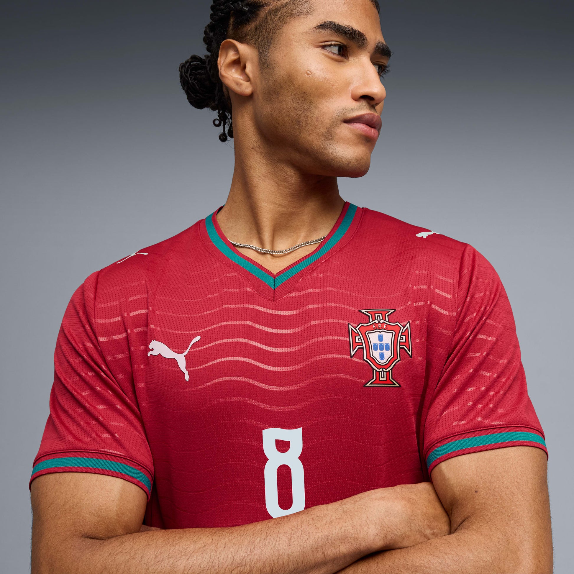 Person wearing aPortugal 2026 World Cup home Stadium Replica Jersey with B. Fernandes #8 printing 