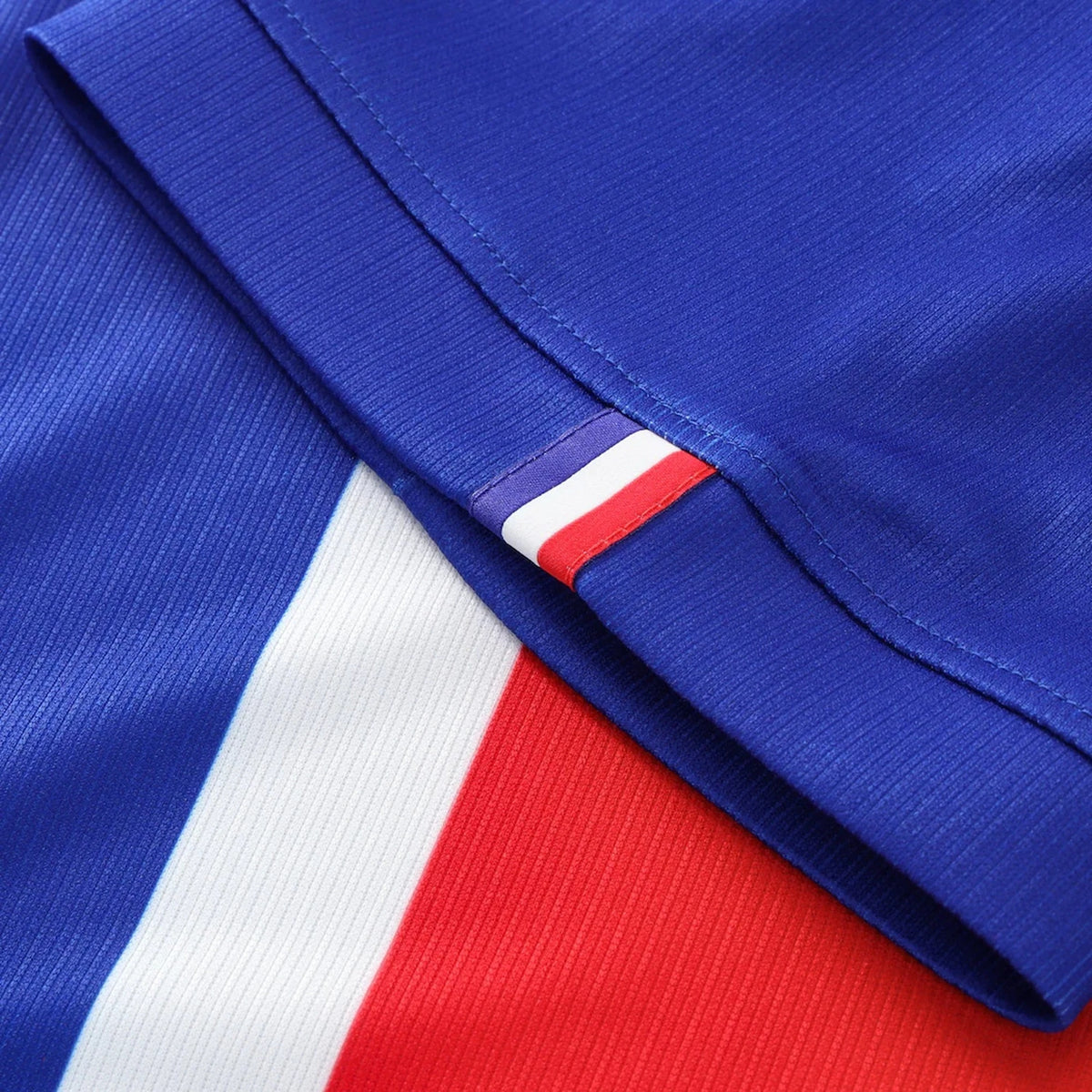 Close-up of a sports jersey with blue, white, and red colors.