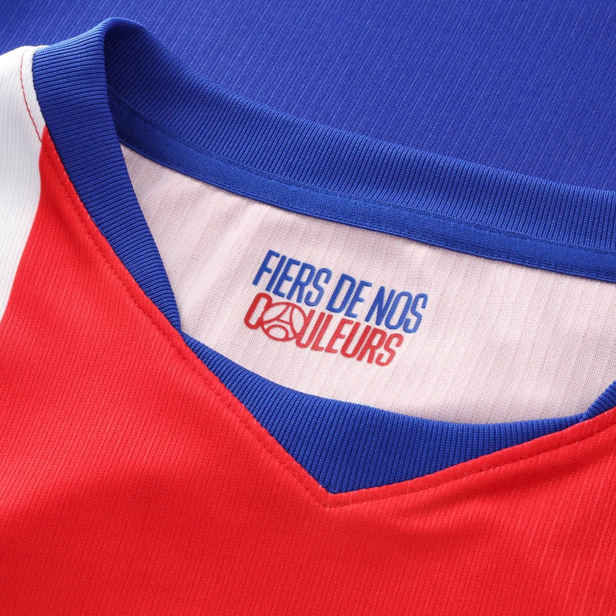 Close-up of a red and blue garment with a visible brand logo on the collar.