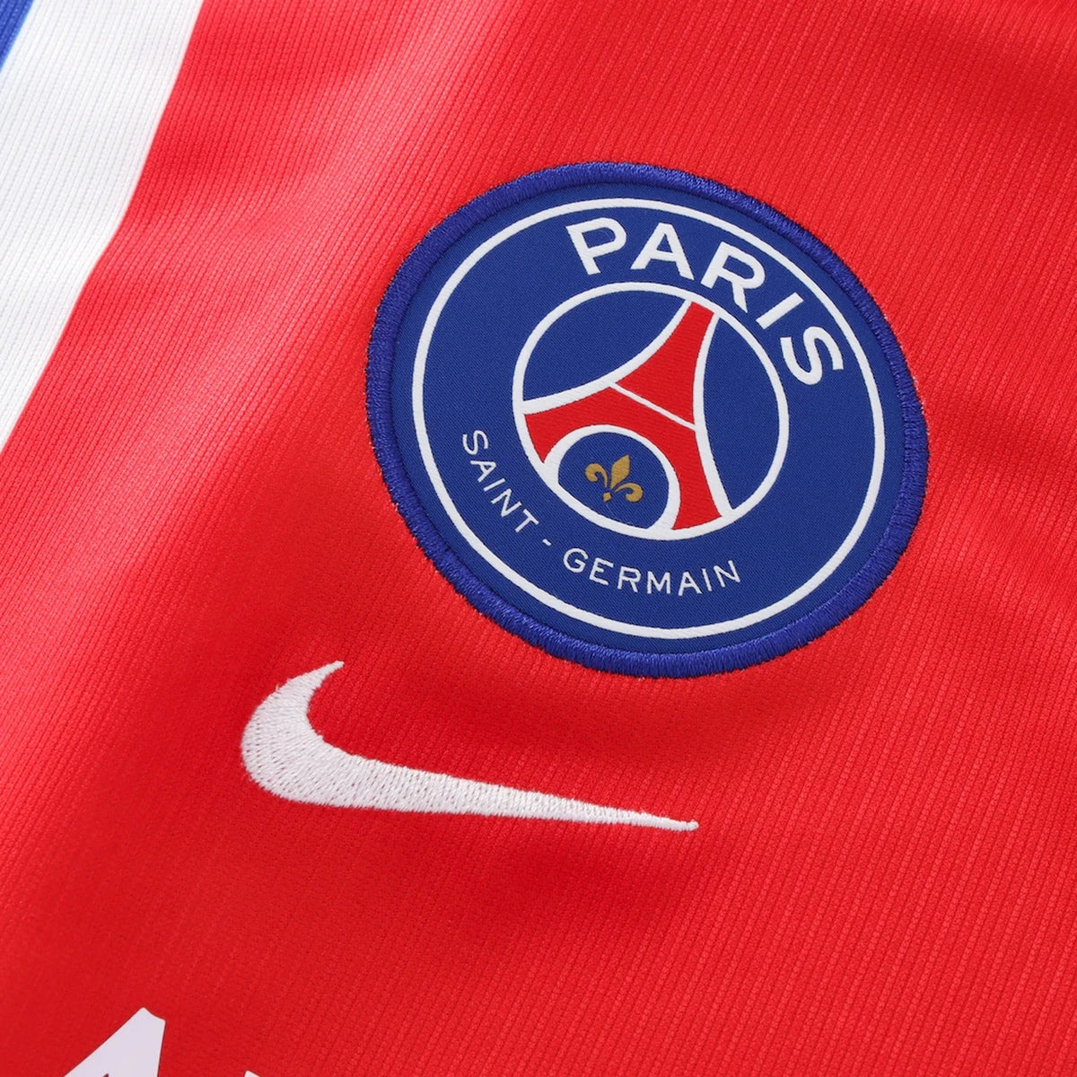 Paris Saint-Germain logo on a red sports jersey with Nike swoosh.
