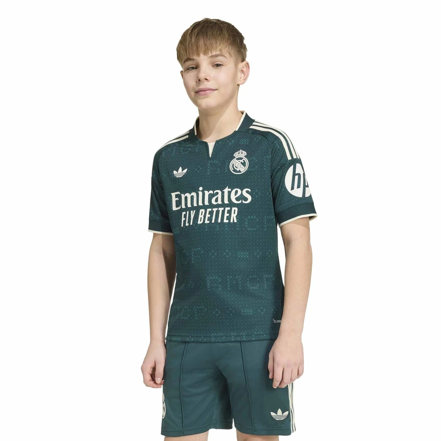 Front view of a kid wearing a  Real Madrid 2026-2027 away green stadium replica soccer jersey 