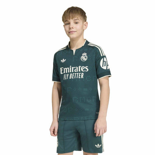 Front view of a kid wearing a  Real Madrid 2026-2027 away green stadium replica soccer jersey 