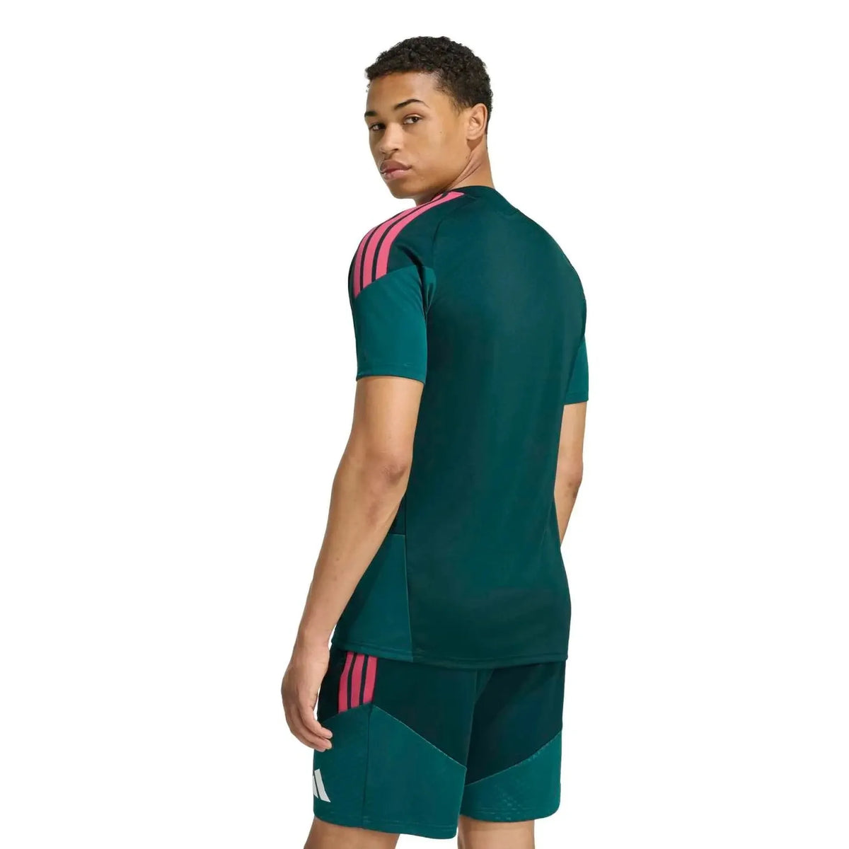 Person wearing a green sports outfit with pink accents on a white background