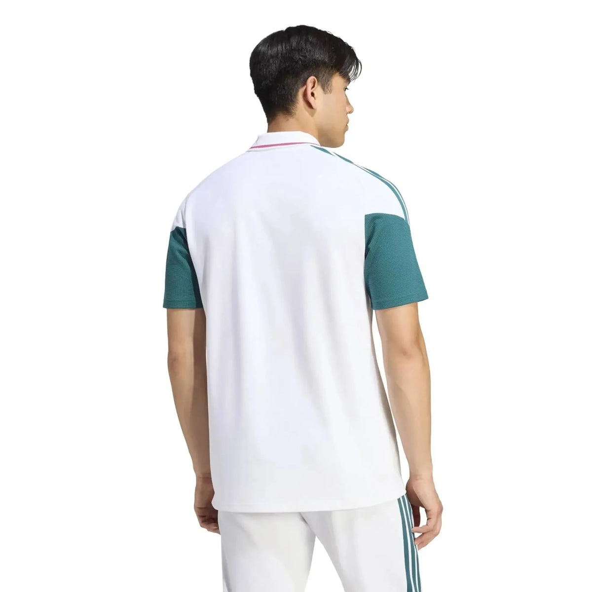 A man shown from the back wearing a white short-sleeve athletic polo shirt with teal green sleeve panels and white pants with teal stripes, against a plain white background.